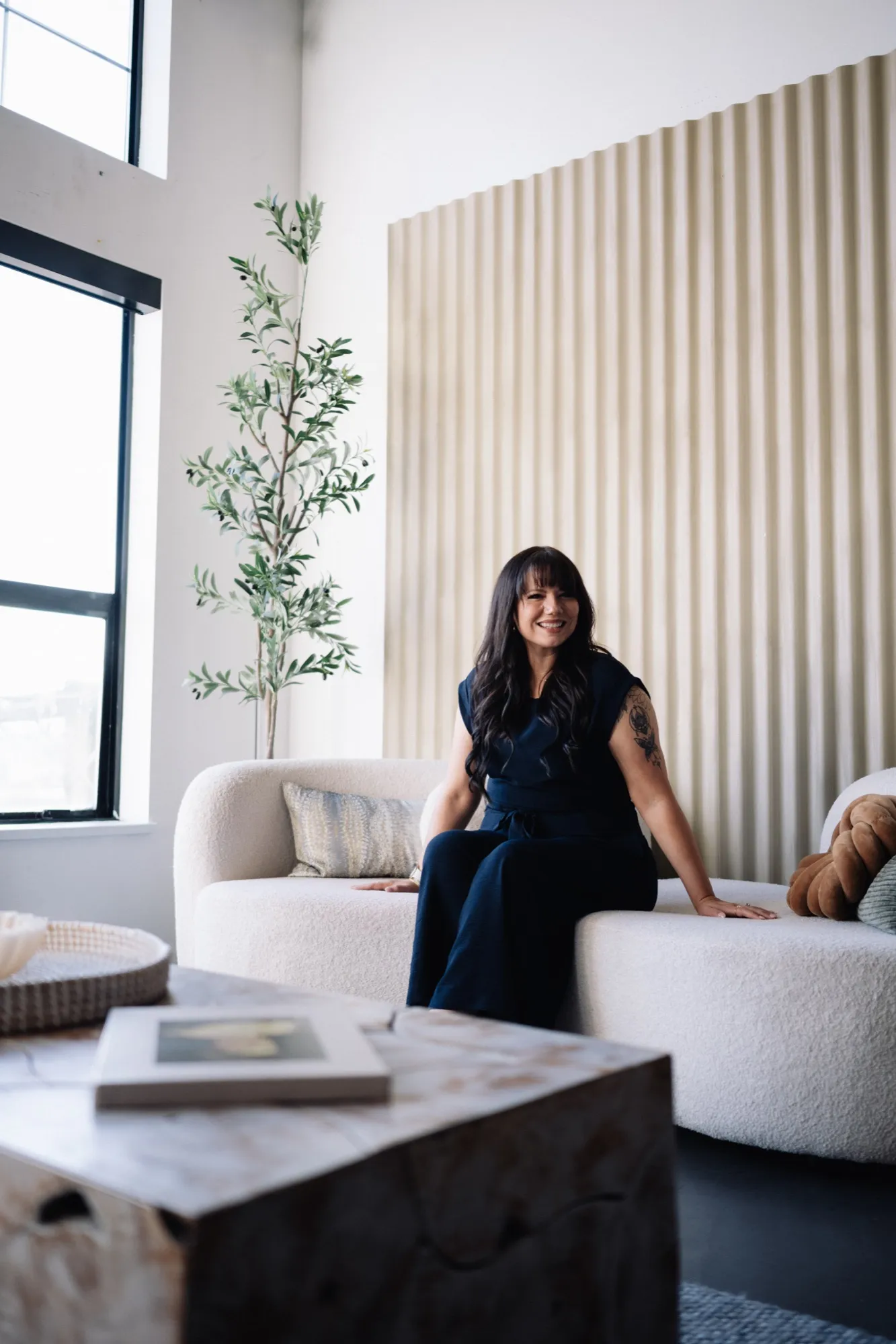 Brooke seated in a bright loft studio