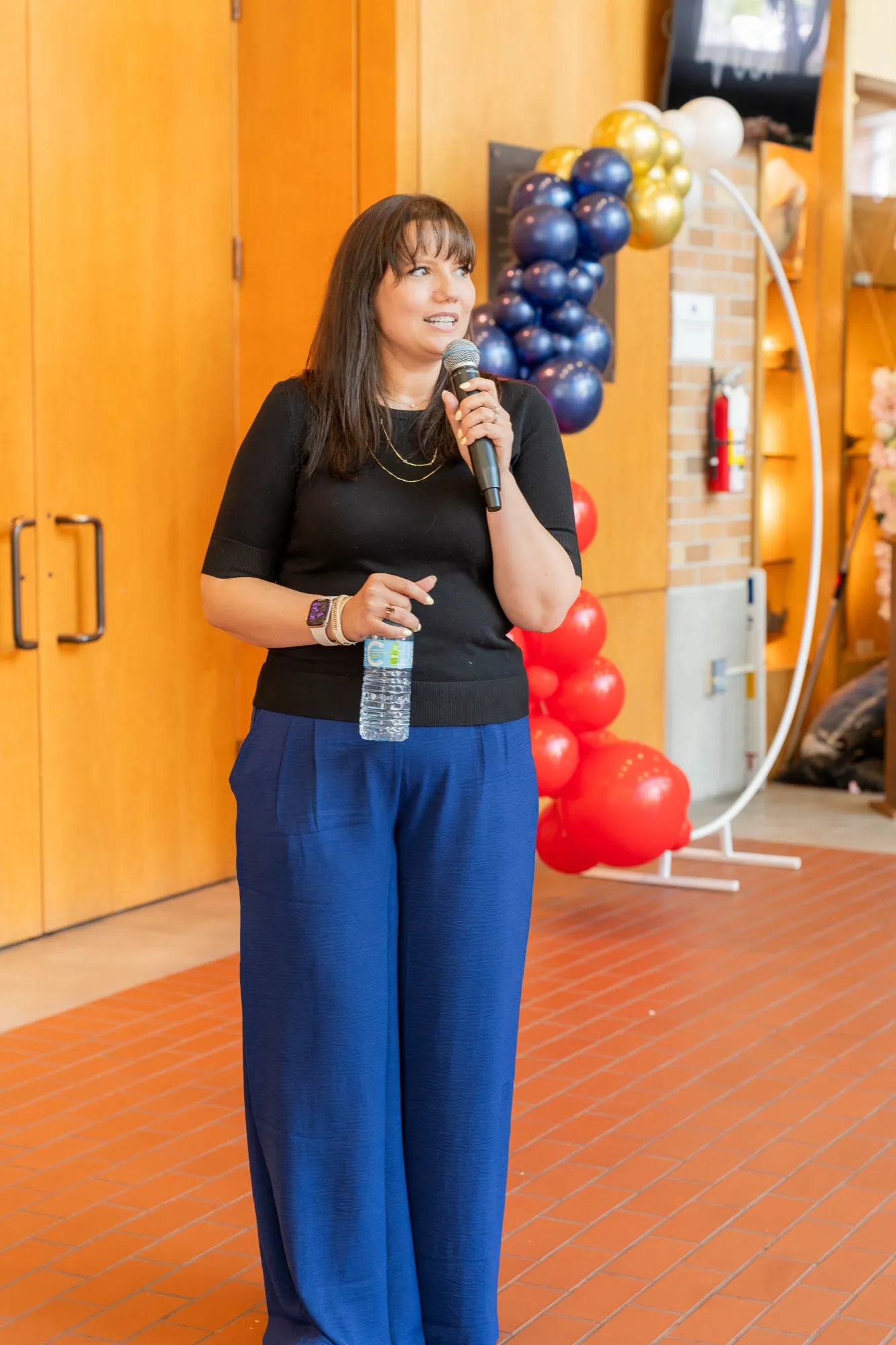 Brooke speaking at the launch, microphone in hand